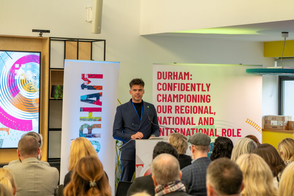 A man presenting at the Durham Champions networking event