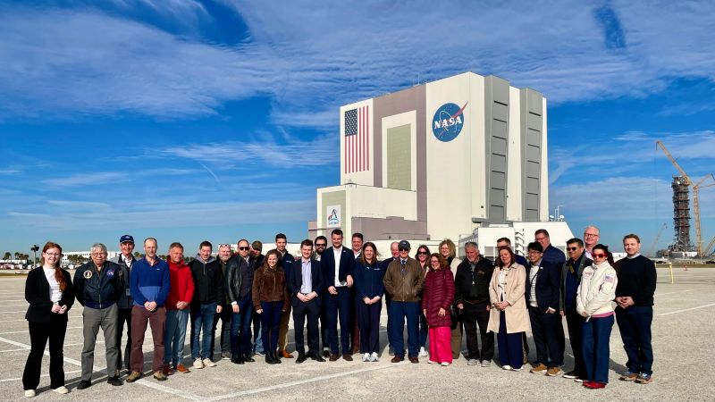 A group of people standing outside of NASA space station