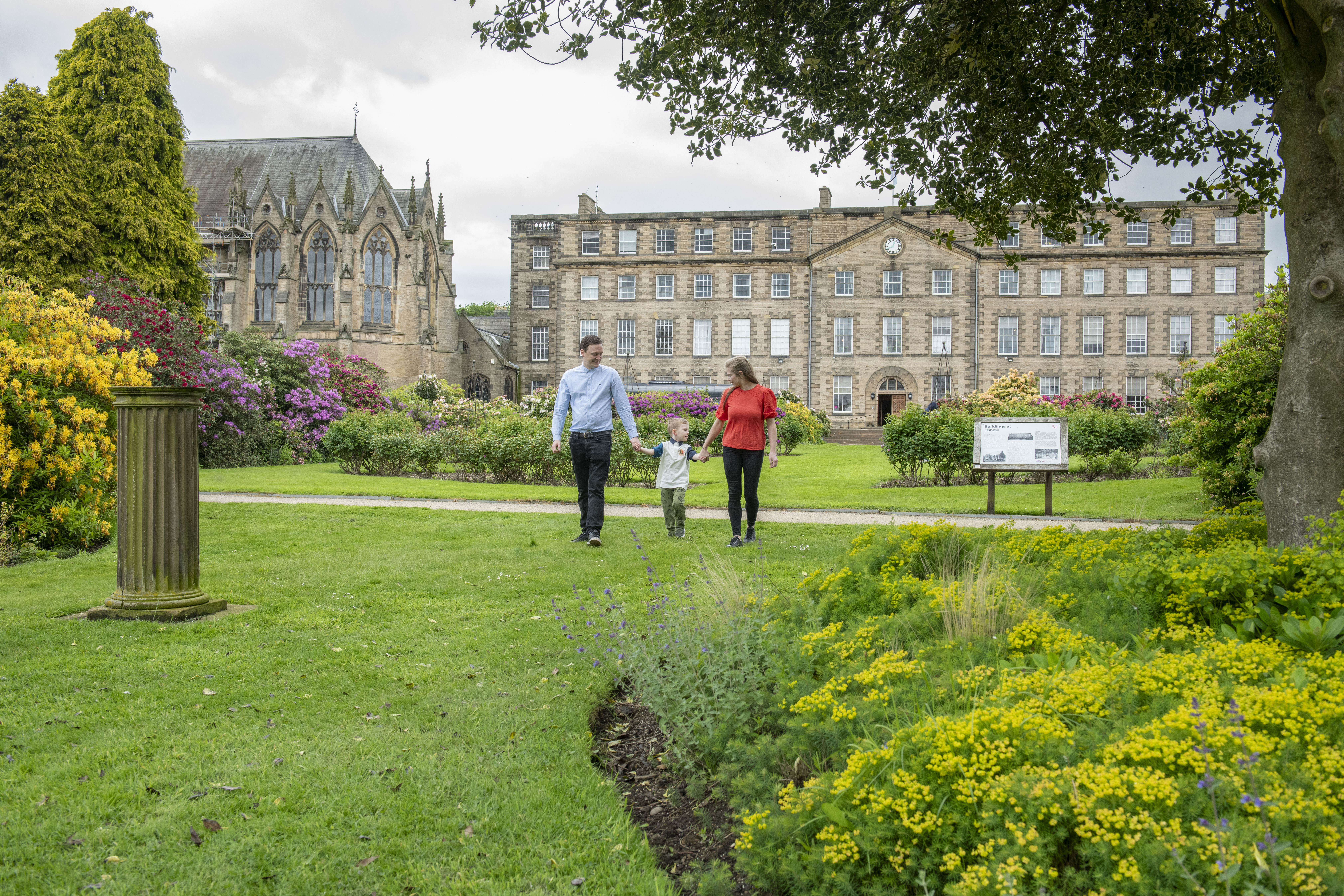 A family walking outside of Ushaw in the garden