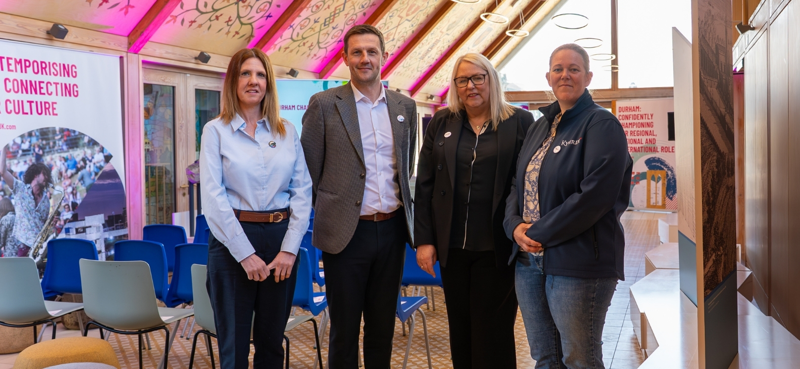 Four Durham Champions stood in a room